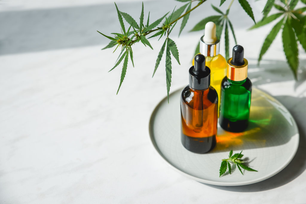 Glass Bottles With Cbd OilThree bottles of cannabis oil sitting on a plate