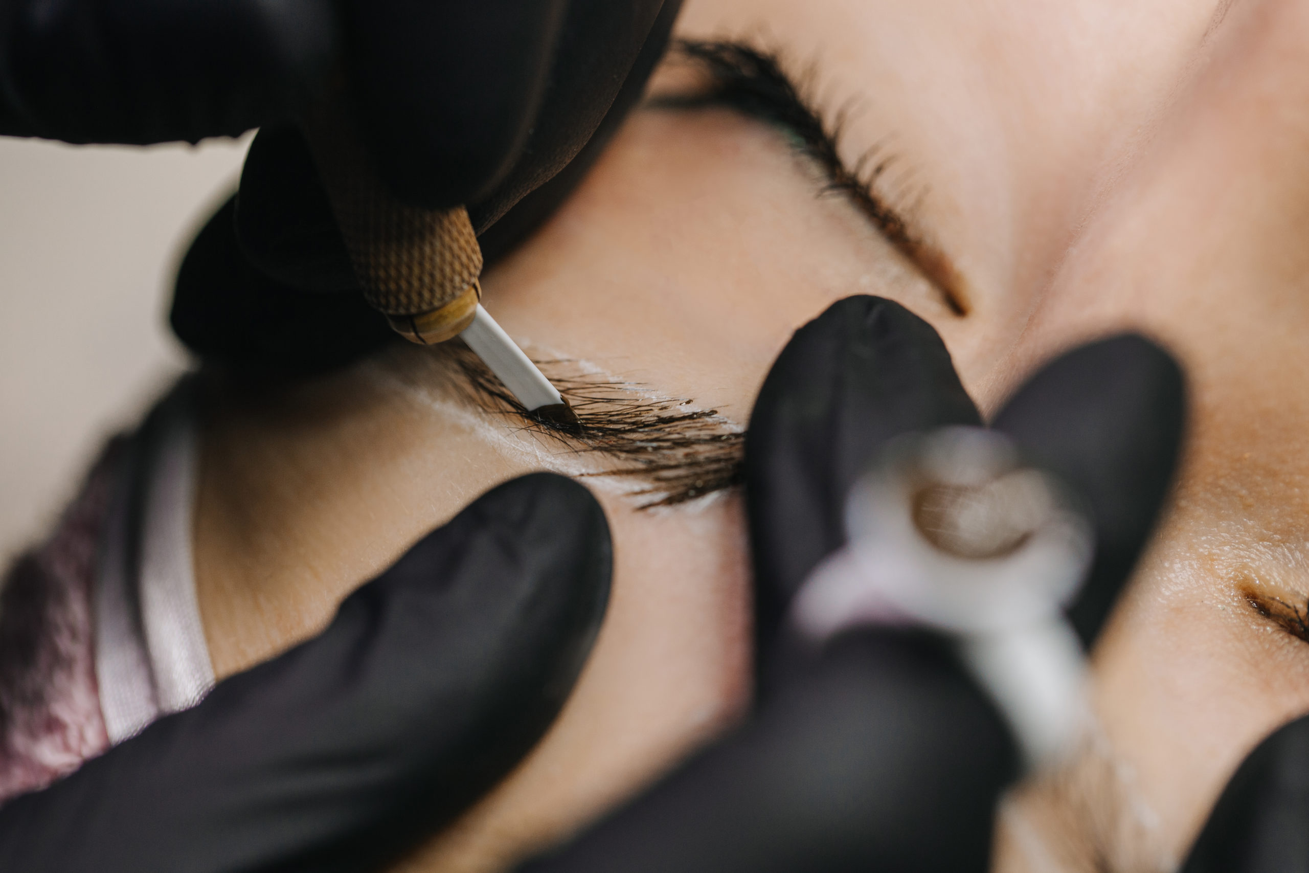 A close up of a woman getting her eyebrows done
