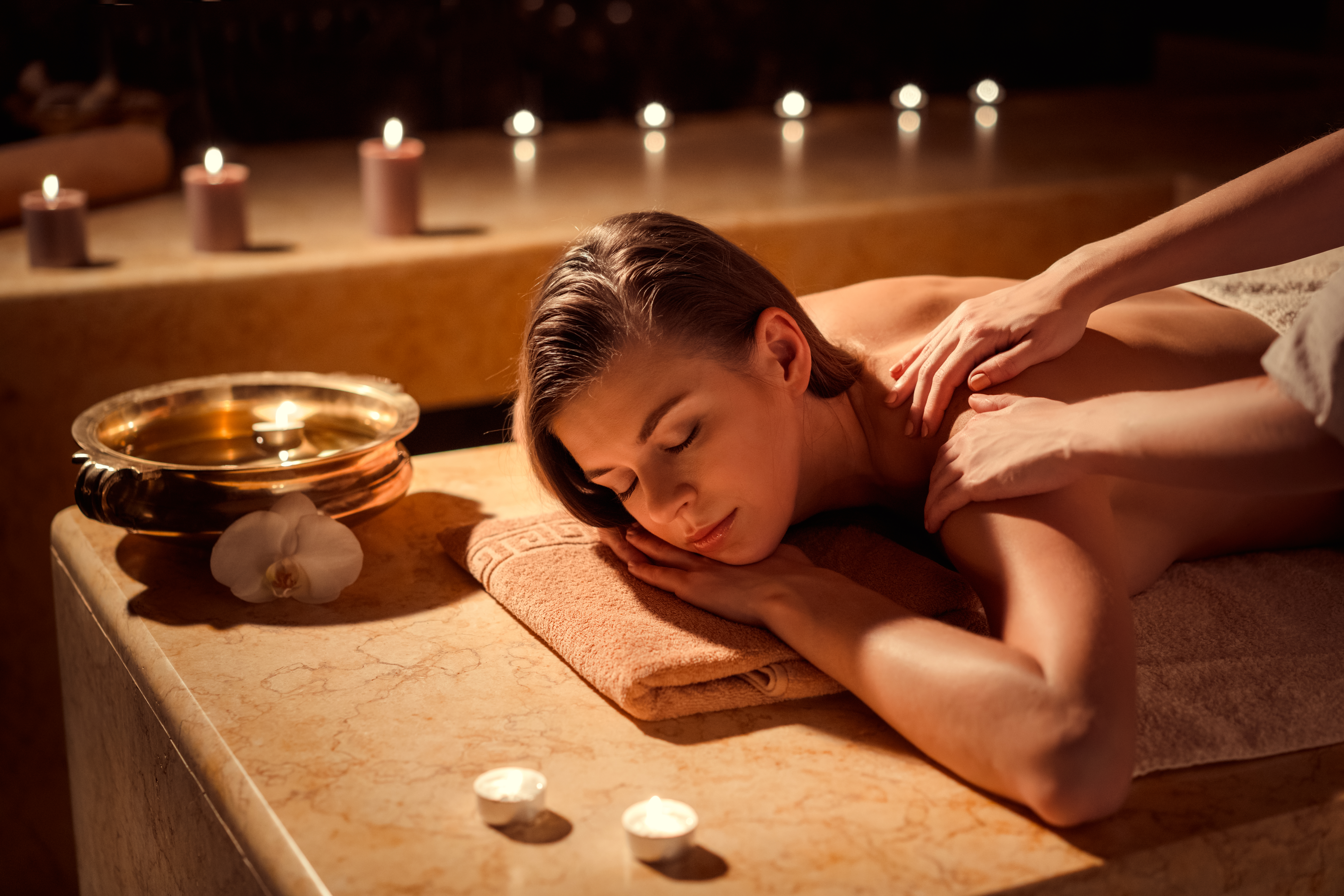 A woman getting a back massage at a spa